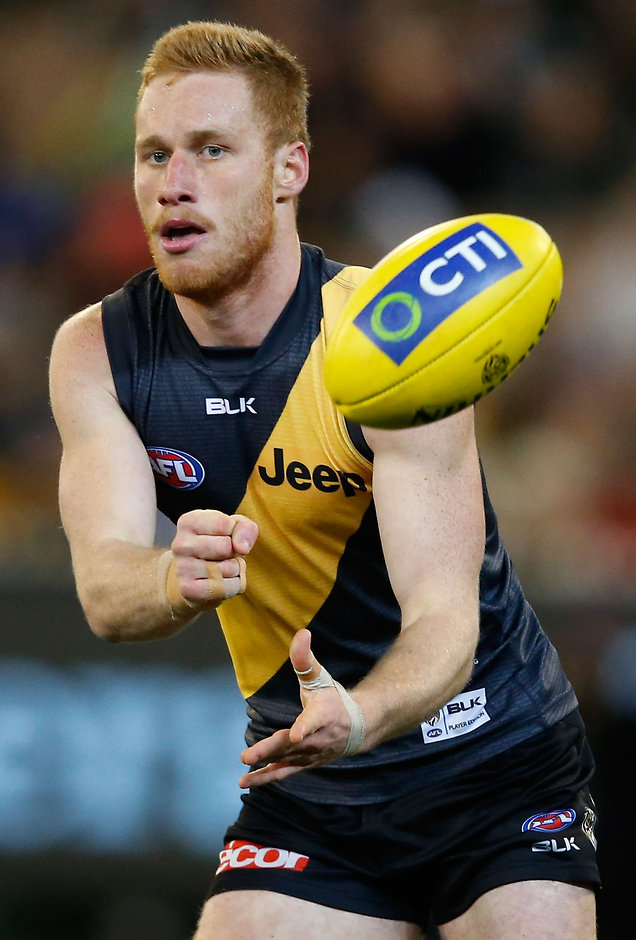 AFL 2015 Rd 15 - Richmond v Carlton MELBOURNE, AUSTRALIA - JULY 10: Nick Vlastuin of the Tigers handpasses the ball during the 2015 AFL round 15 match between the Richmond Tigers and the Carlton Blues at the Melbourne Cricket Ground, Melbourne, Australia on July 10, 2015. (Photo by Adam Trafford/AFL Media)